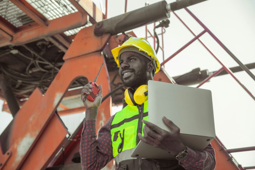 happy worker foreman working loading control in cargo shipping industry. engineer work logistics